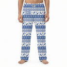Model wearing I'd Rather Be Skiing lounge pants with snowflakes and pine trees pattern on white background.