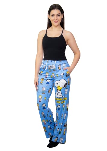 Model standing wearing Snoopy Friends pajama lounge pants over white background