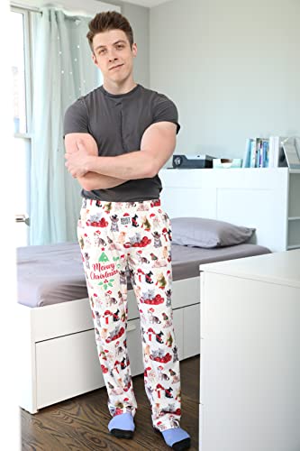 Image of male model posing in front of bed wearing Meowy Christmas pajama lounge pants (front view)