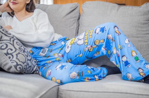 Model laying down on gray couch wearing Snoopy Friends pajama lounge pants