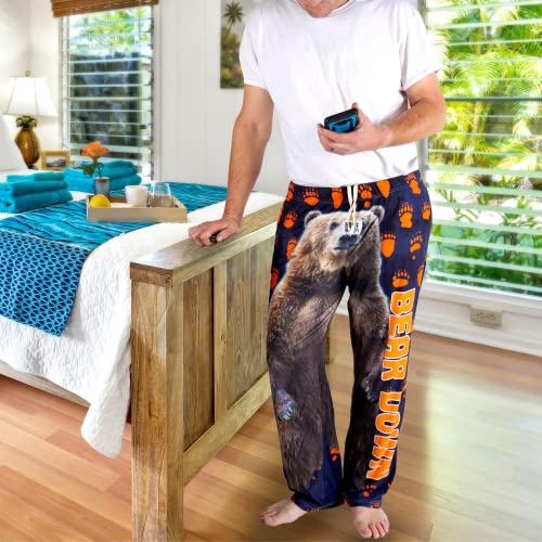 Image of male model posing at the edge of bed wearing Bear Down pajama lounge pants (front view)