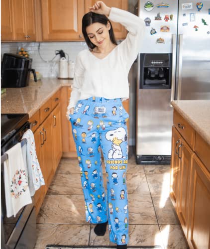 Model posing in a kitchen wearing Snoopy Friends pajama lounge pants