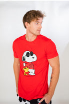 Image of male model standing and looking off into the distance wearing Peanuts Snoopy Joe Cool short sleeve T-shirt (front view white background)