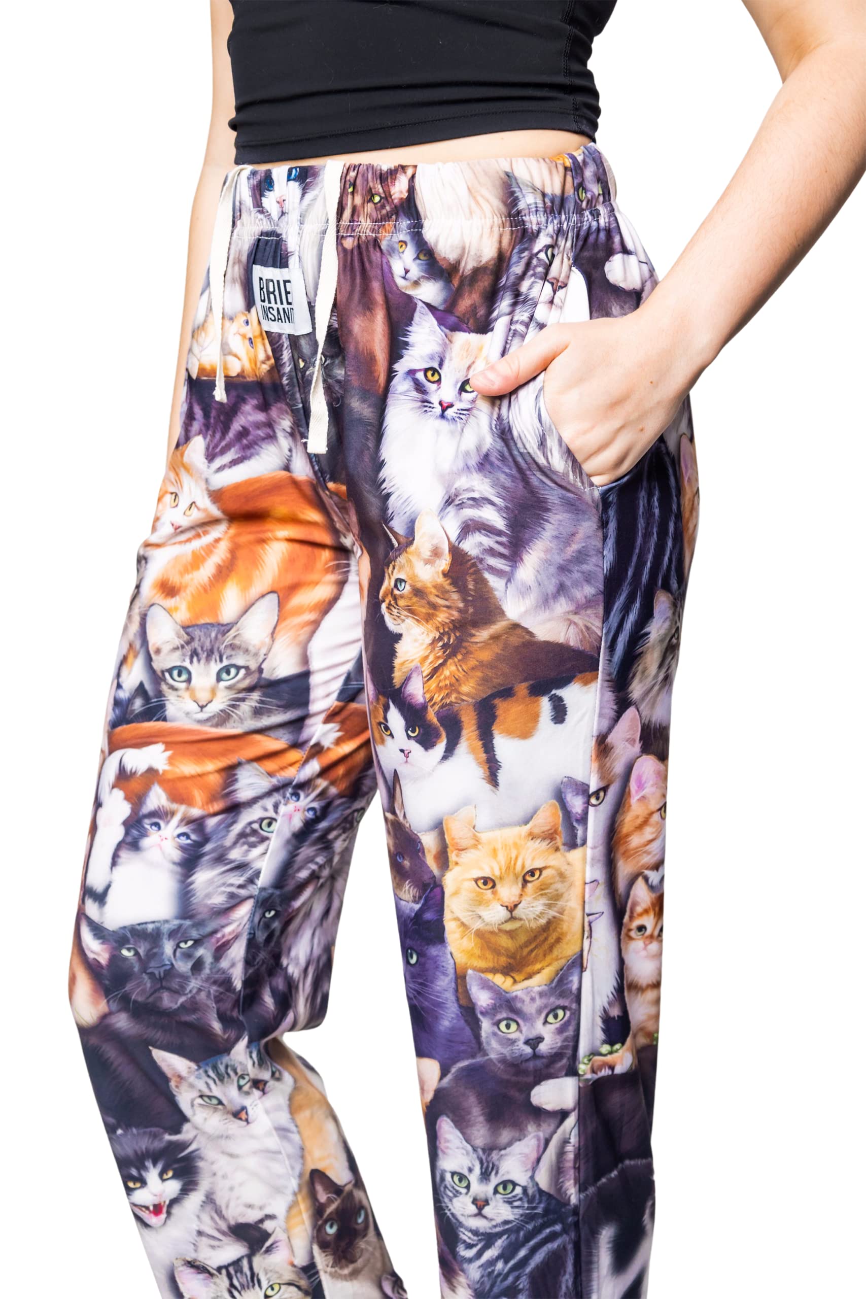 Waist down photo of model wearing All Over Cat pajama lounge pants side view with hand in pocket (white background)