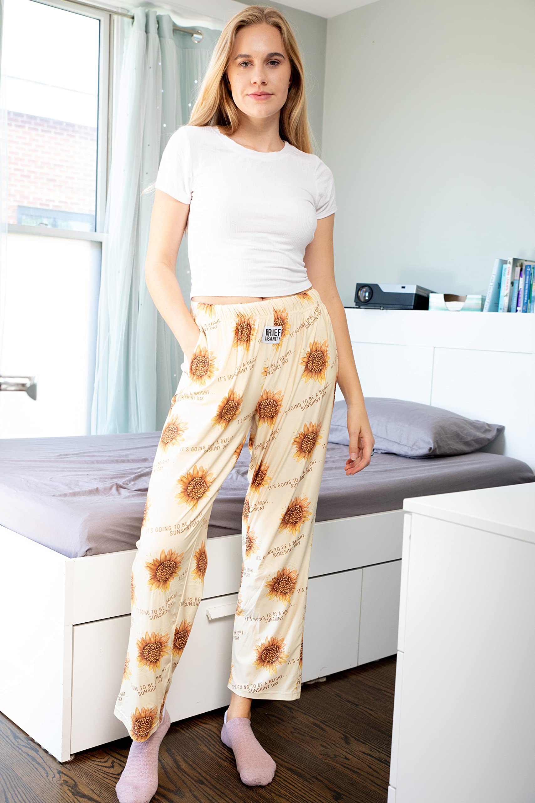 Female model standing forward in front of a bed posing in Cheer Me Up pajama lounge pants