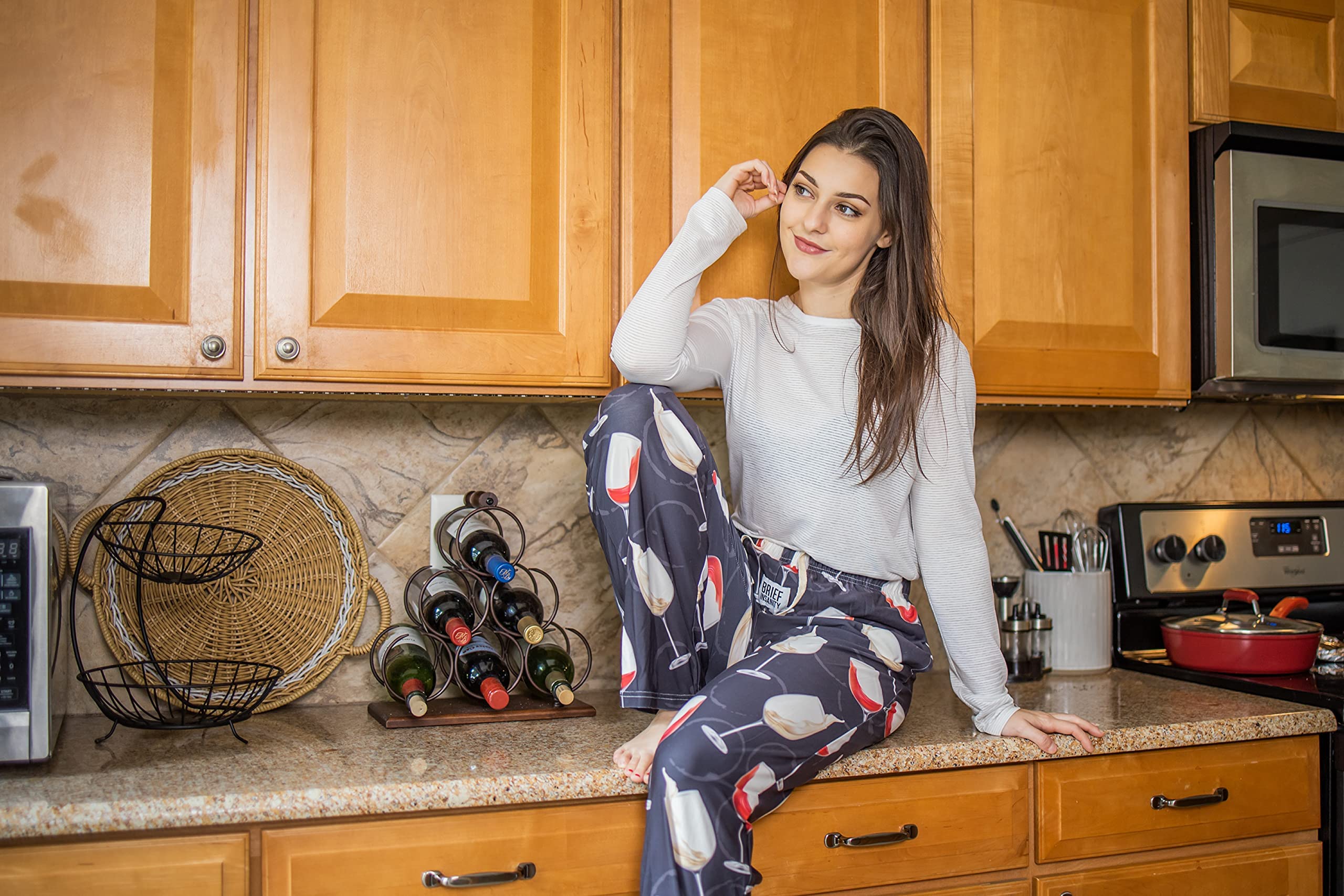 Female model sitting on kitchen counter wearing You Whine I Wine pajama lounge pants