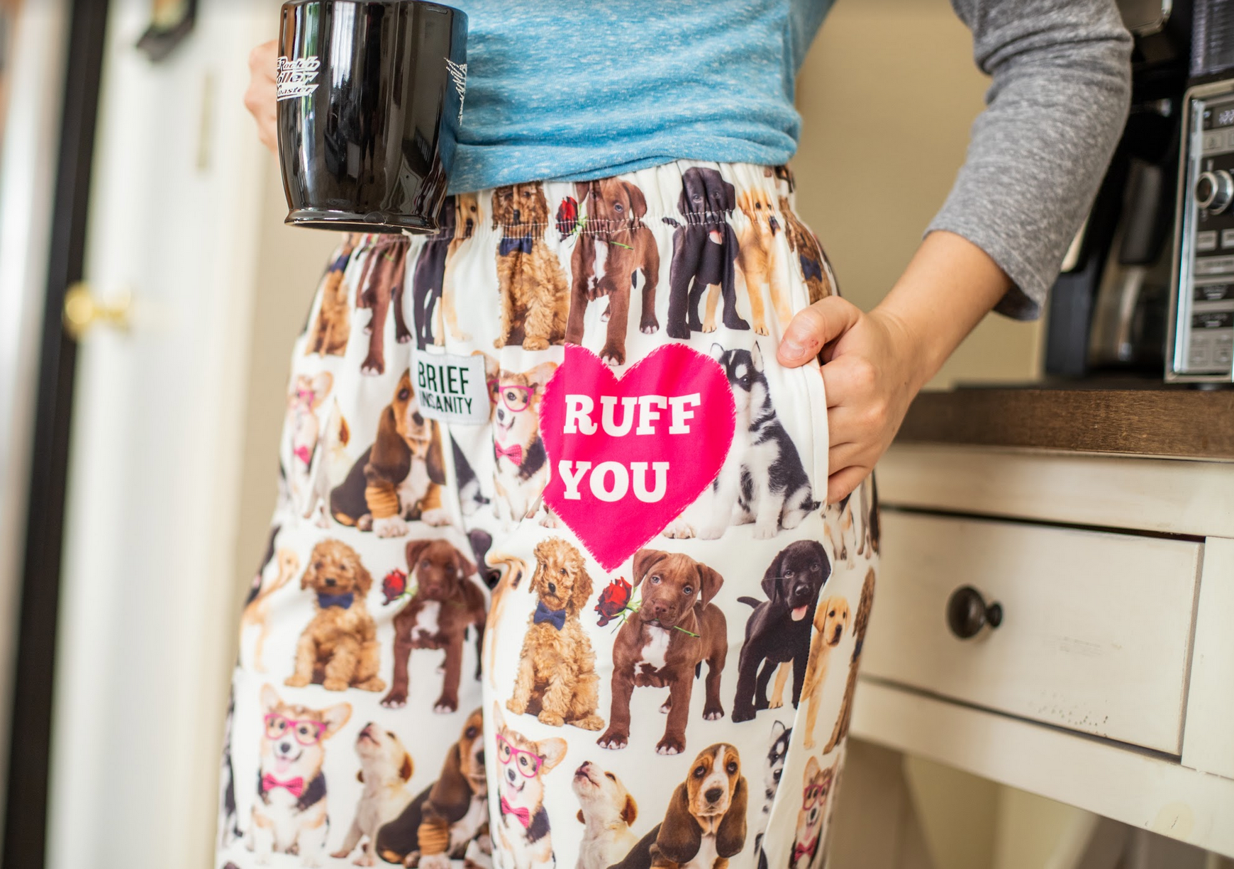 Close up cropped image of model wearing I Ruff You pajama lounge pants with hand in pocket (front view)