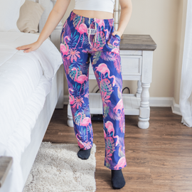 Female model posing and wearing Flamingo pajama lounge pants (front view)