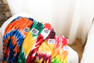 Image of a group of lounge pants laid out on arm of couch