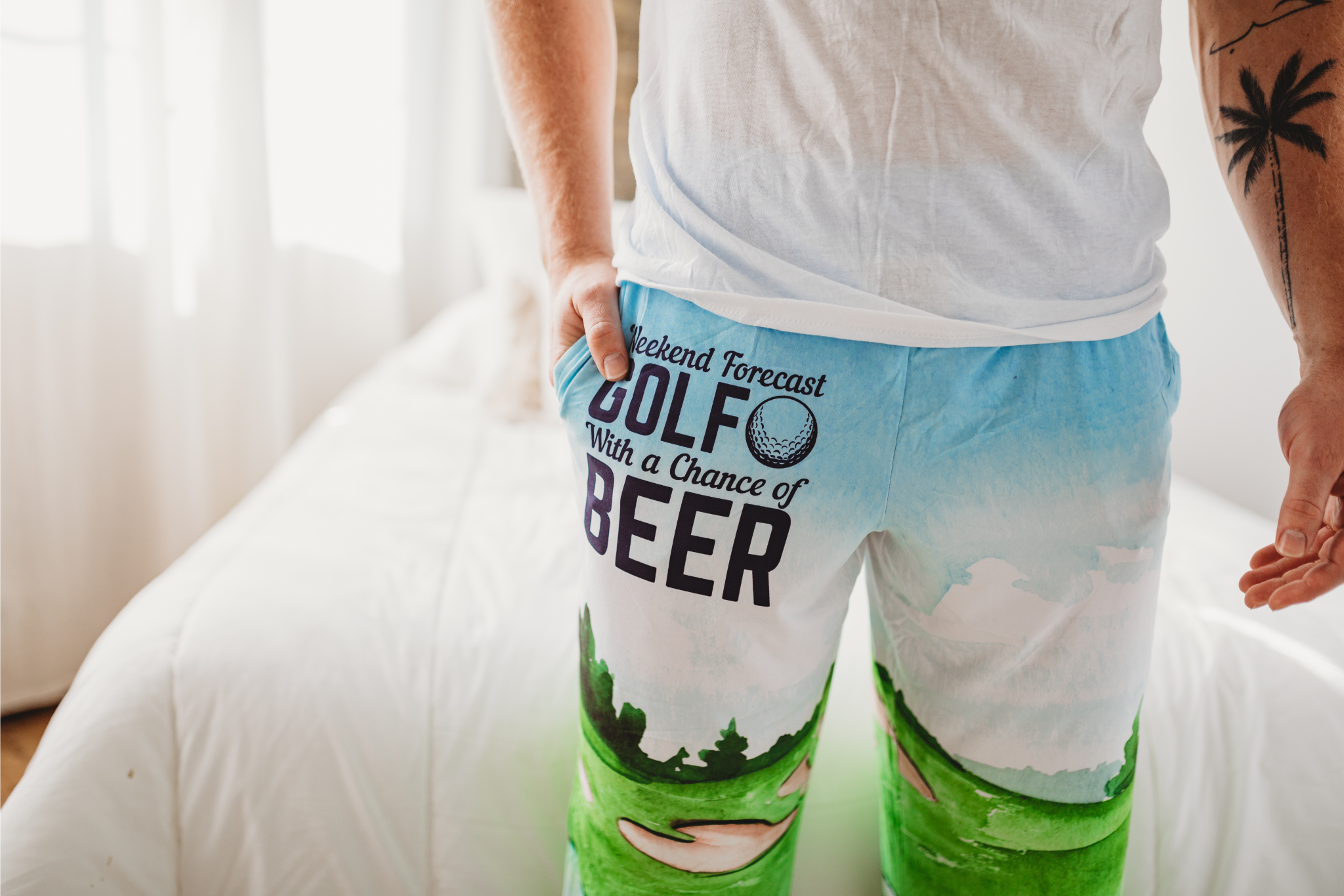 Close up cropped image of male model wearing Golf With A Chance Of Beer pajama lounge pants (front view)