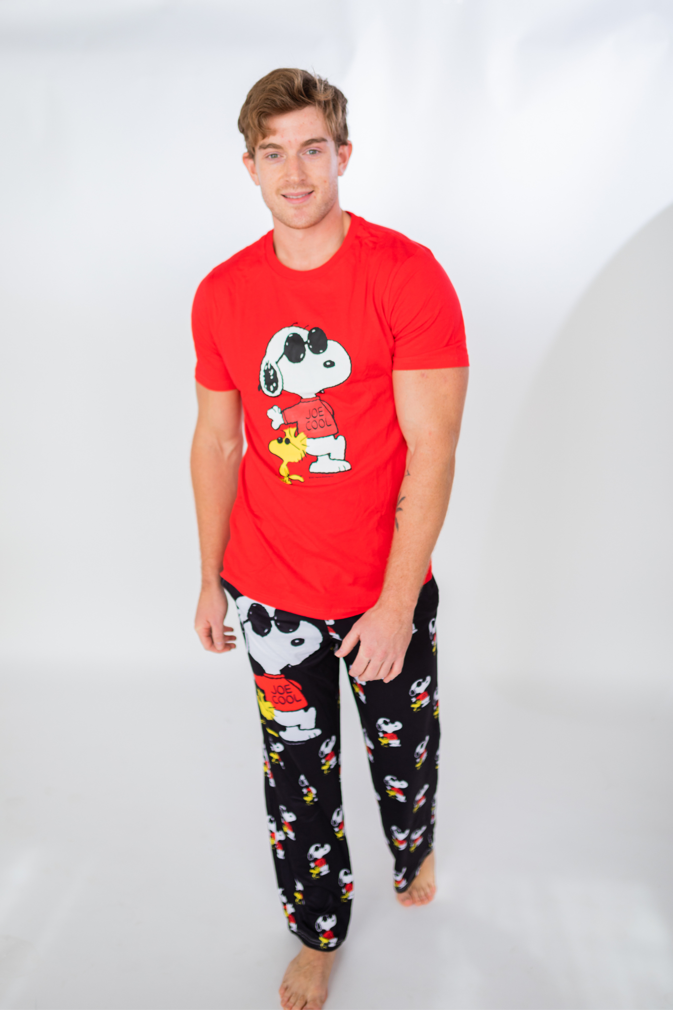 Image of model walking and wearing Snoopy Joe Cool pajama lounge pants front view (white background)