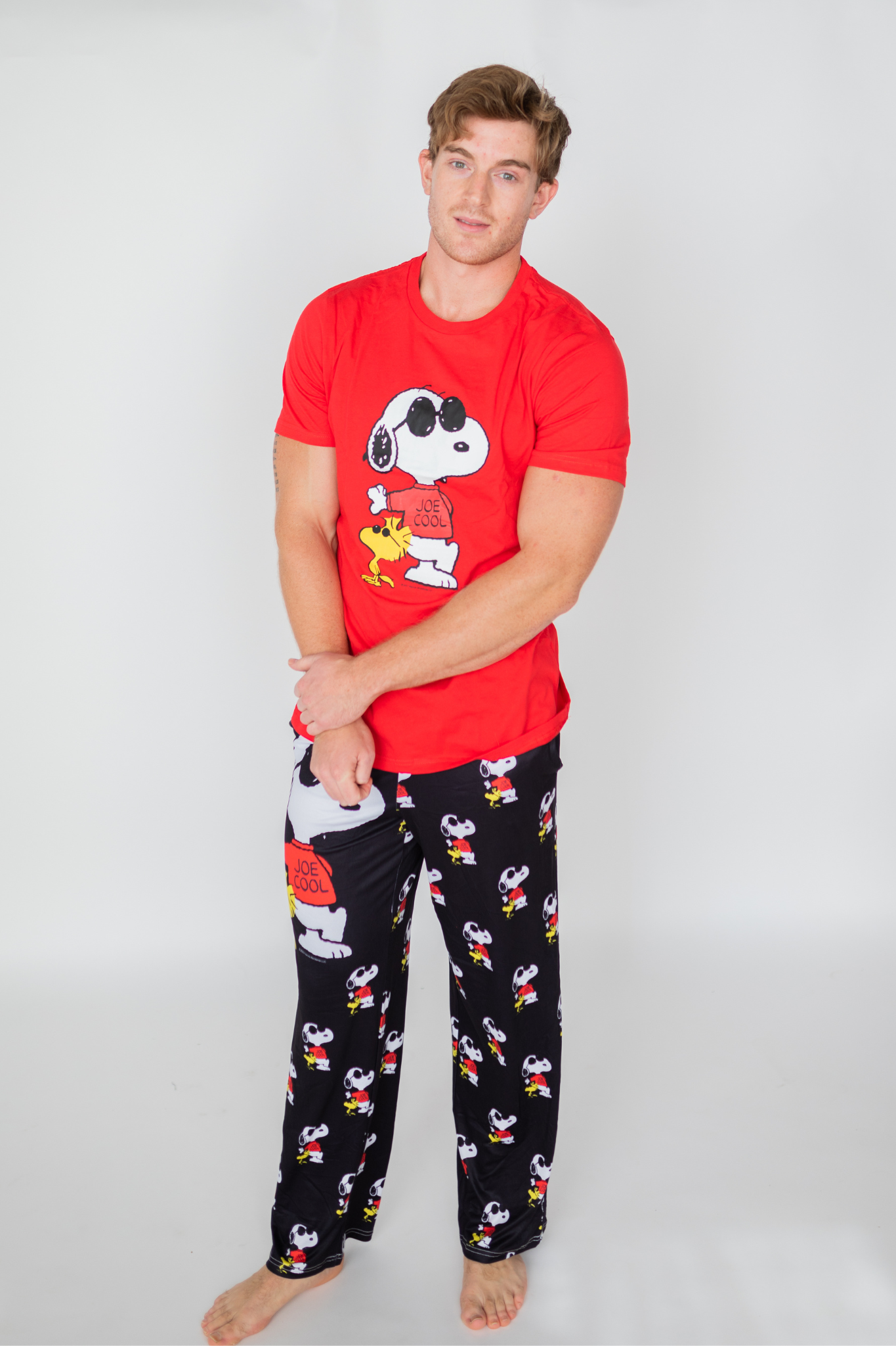 Image of model standing and wearing Snoopy Joe Cool pajama lounge pants front view (white background)