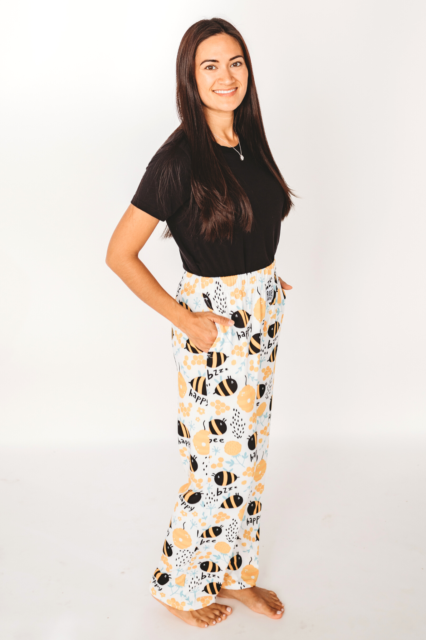 Image of model posing wearing Honey Bee pajama lounge pants side view (white background)