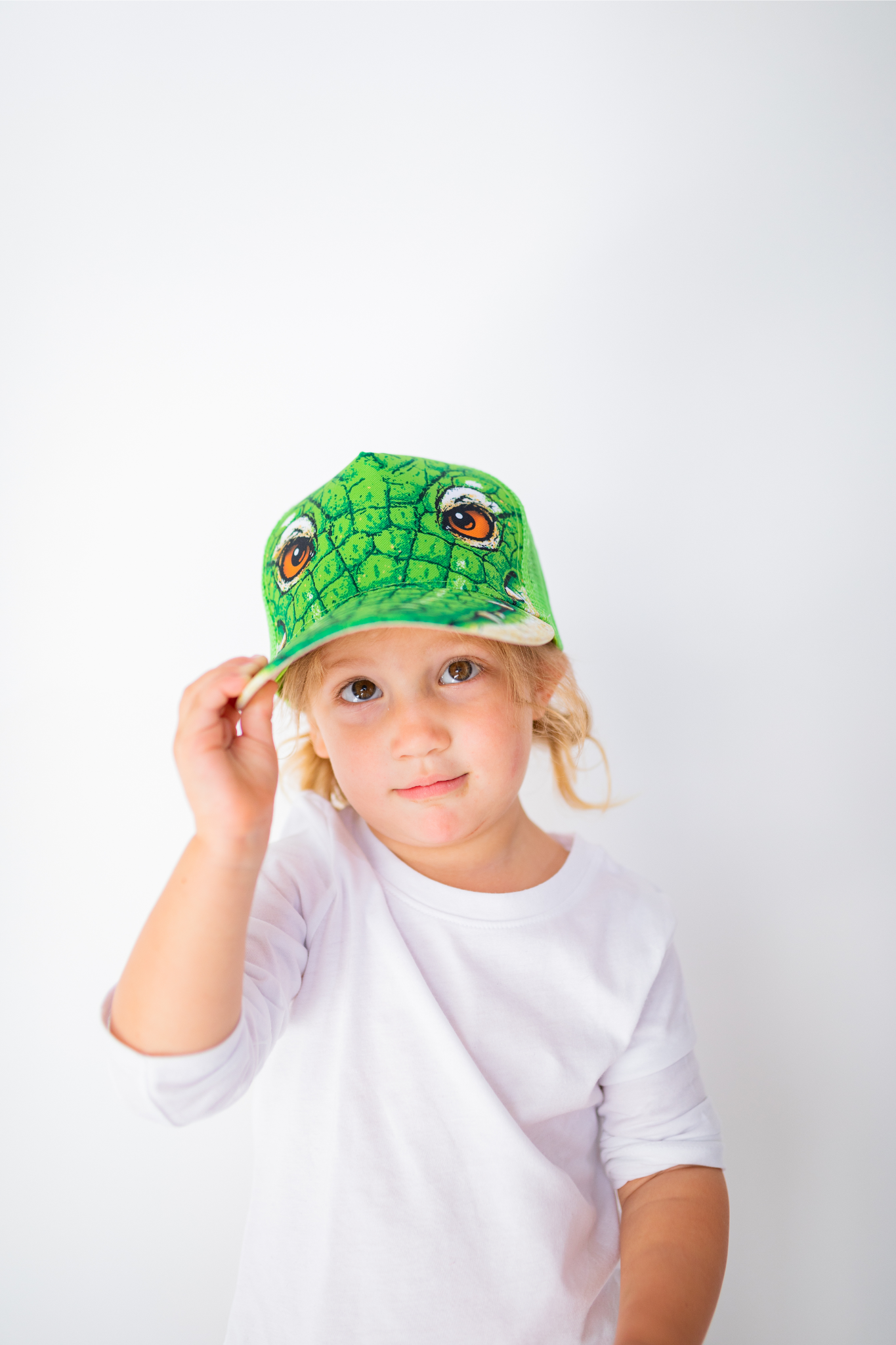 Image of little girl model wearing Gator cap and holding with one hand (front view white background)